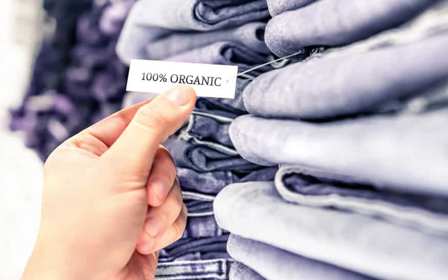 organic jeans, ethical denim pants. stack of clothes in store sh